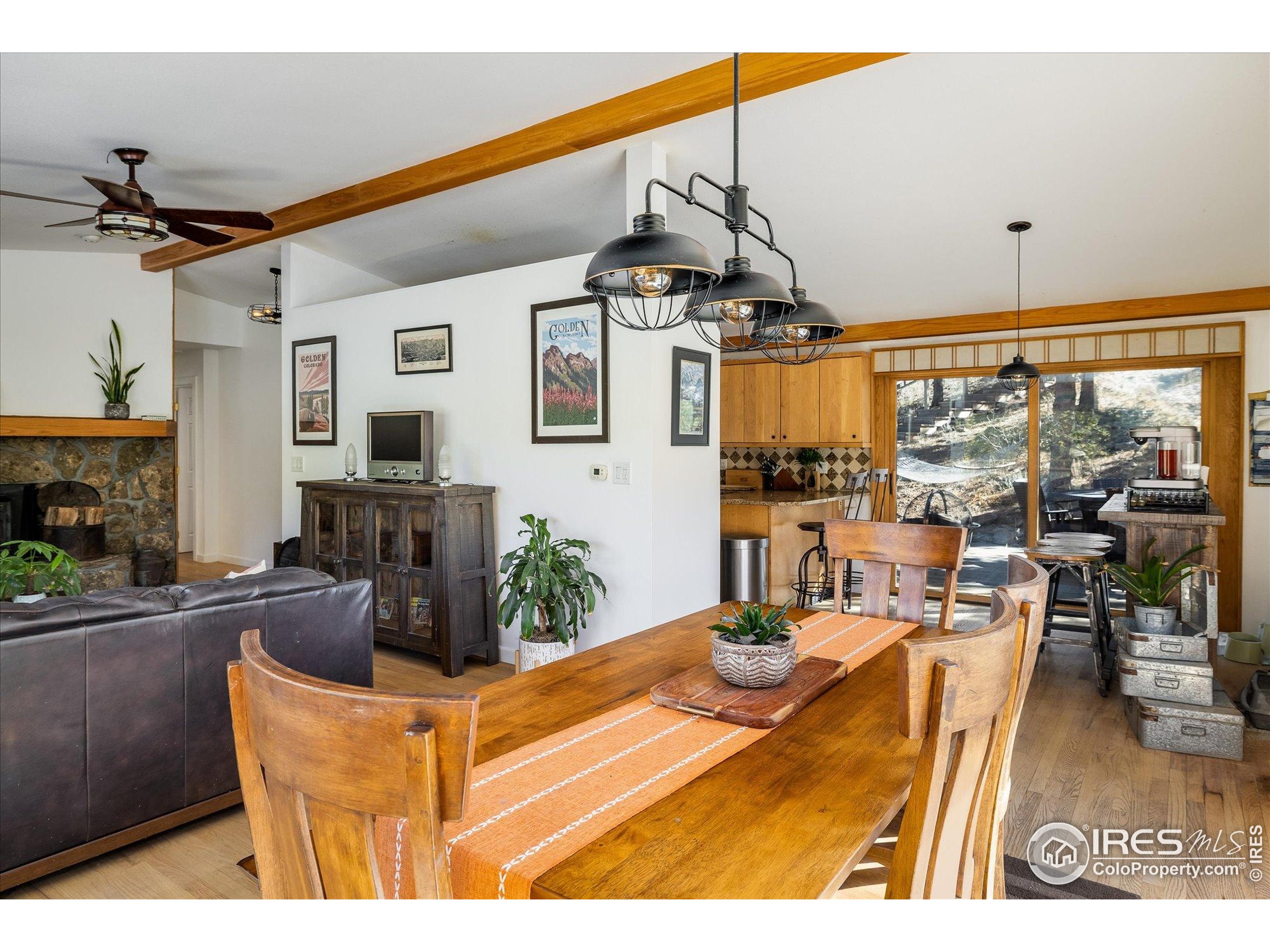 11935 Vonnie Claire Road Golden, CO 80403 - Photo 18 of 42 a view of a dining room with furniture water and chandelier