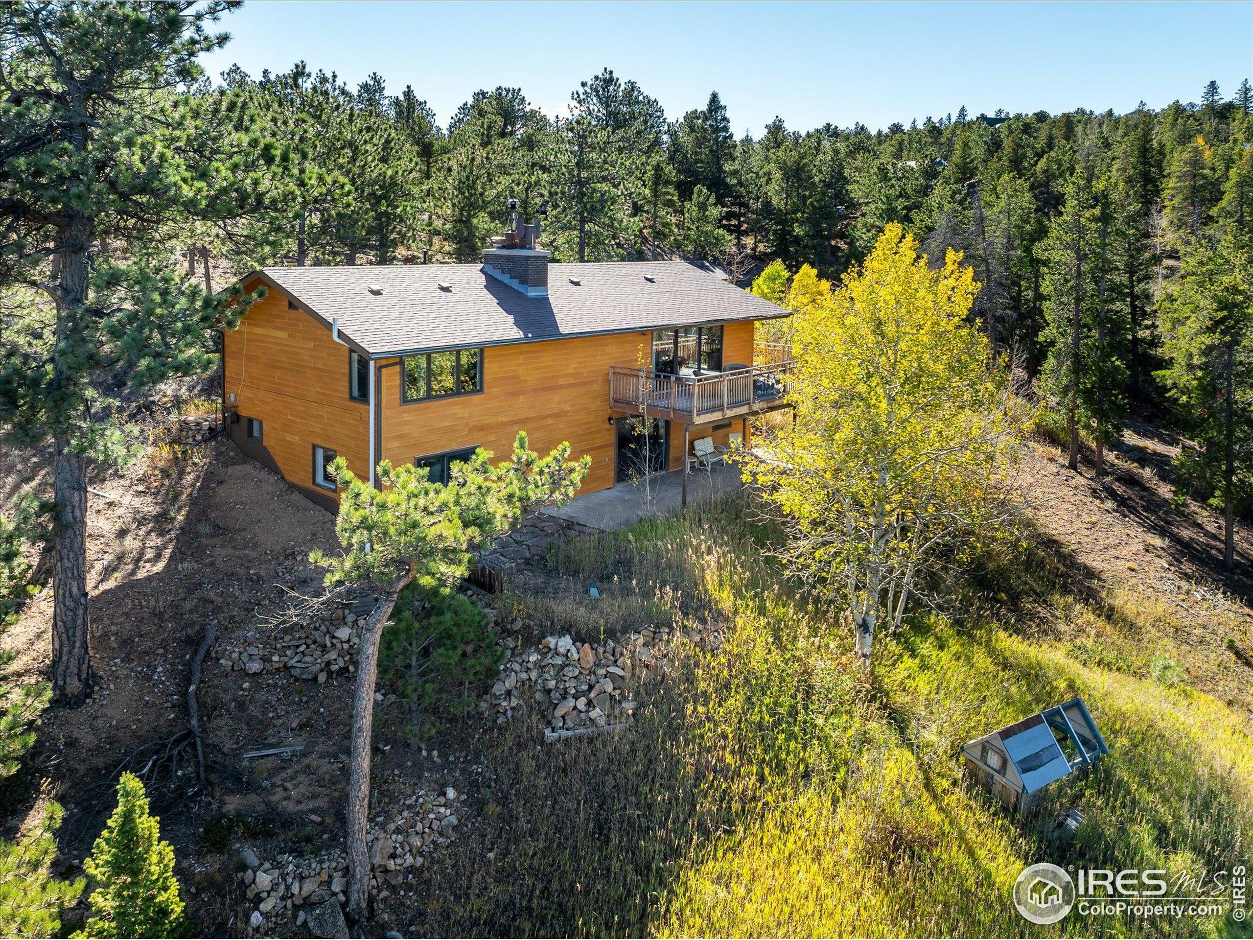 11935 Vonnie Claire Road Golden, CO 80403 - Photo 2 of 42 a view of a house with a yard and sitting area