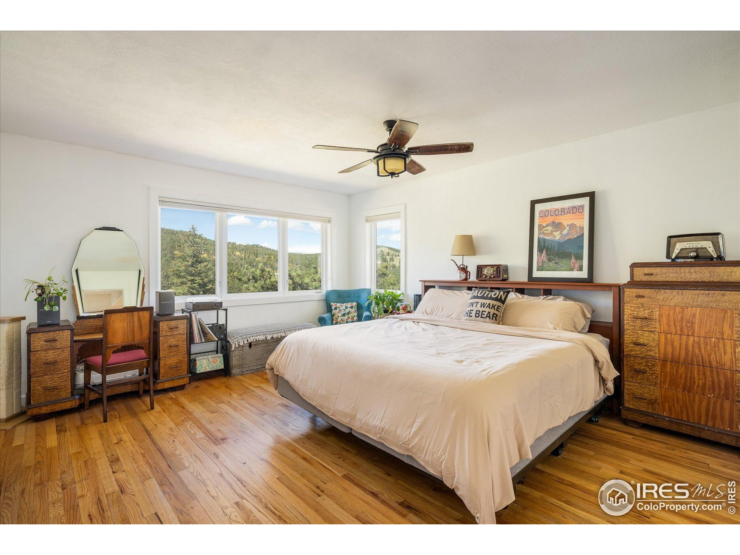 11935 Vonnie Claire Road Golden, CO 80403 - Photo 24 of 42 a bed room with a bed and a lounge chair