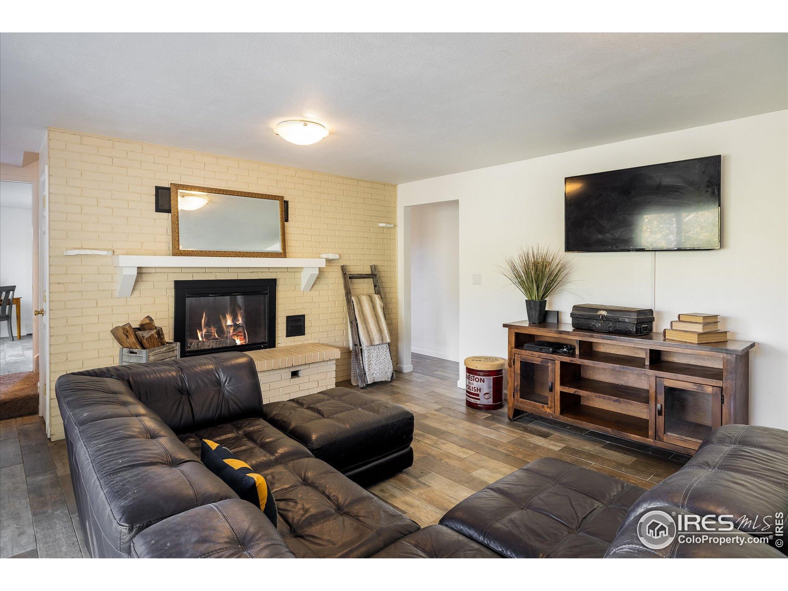 11935 Vonnie Claire Road Golden, CO 80403 - Photo 30 of 42 a living room with furniture and a fireplace