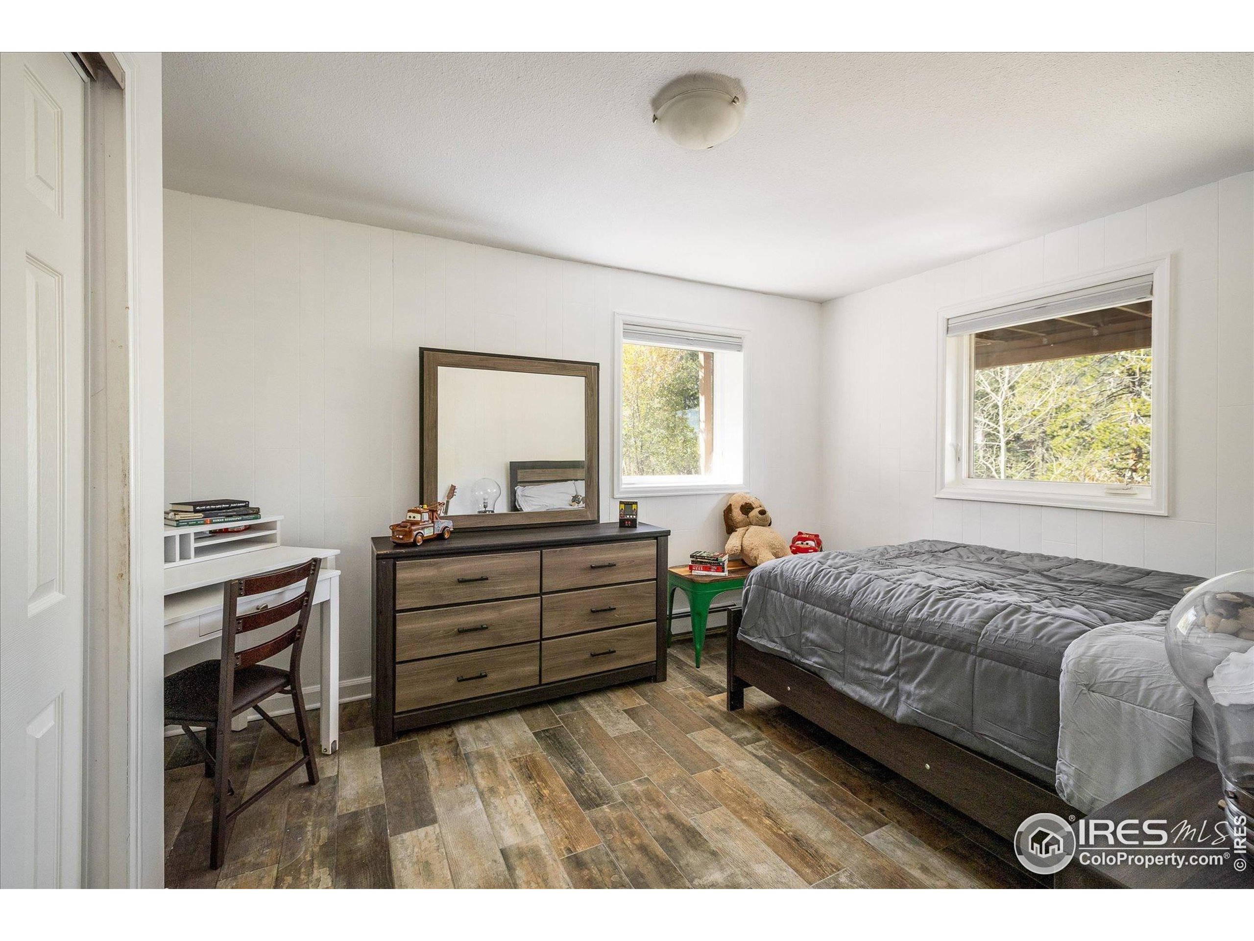 11935 Vonnie Claire Road Golden, CO 80403 - Photo 34 of 42 a bedroom with a bed and a dresser