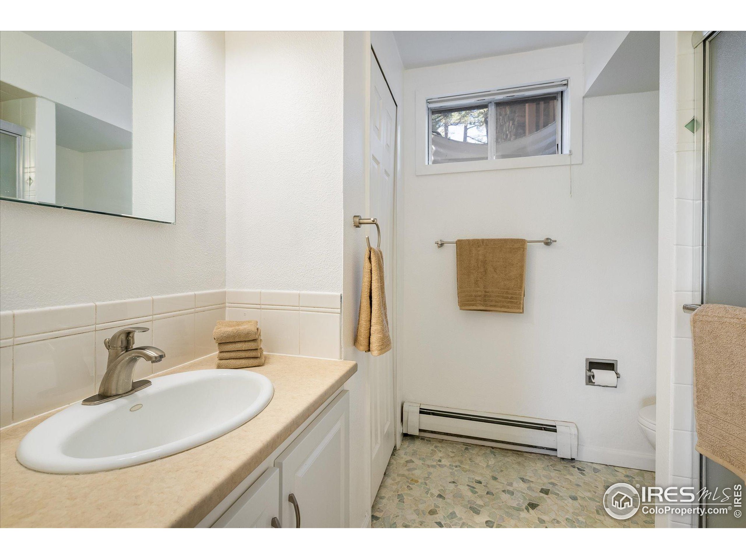 11935 Vonnie Claire Road Golden, CO 80403 - Photo 35 of 42 a bathroom with a sink and a mirror