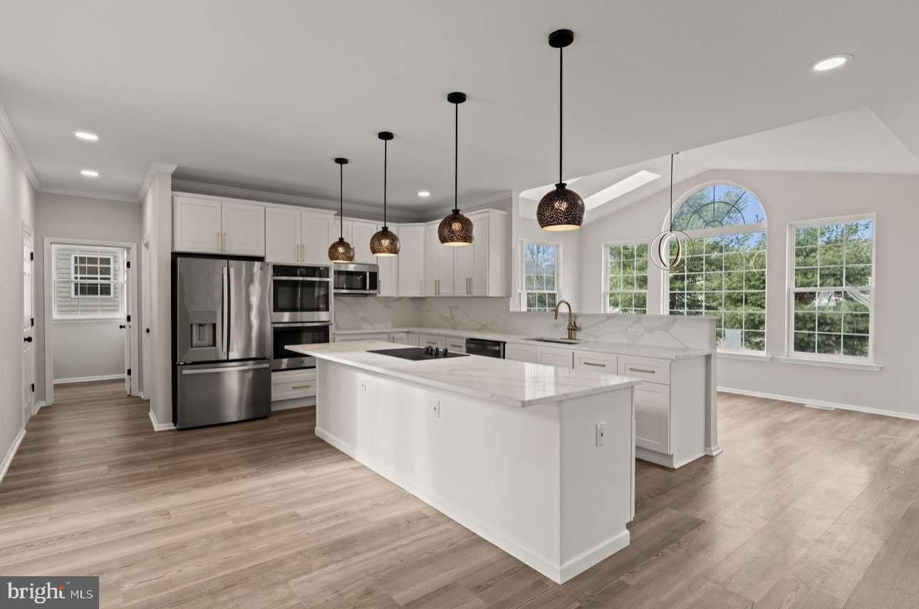 4 Box Turtle Lane Sicklerville, NJ 08081 - Photo 11 of 37 a kitchen with stainless steel appliances granite countertop a sink a stove and a wooden floor