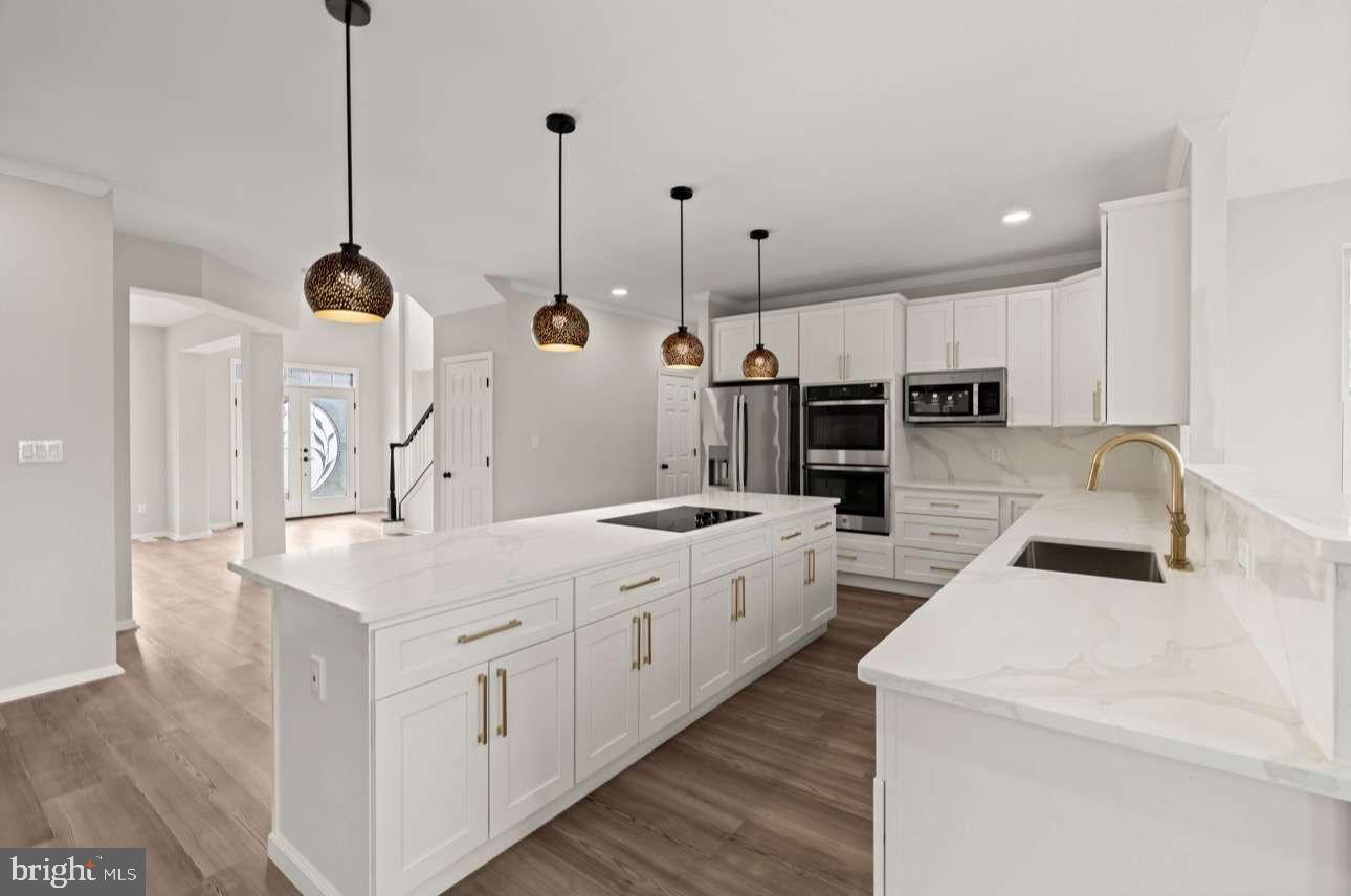 4 Box Turtle Lane Sicklerville, NJ 08081 - Photo 13 of 37 a kitchen with white cabinets and stainless steel appliances