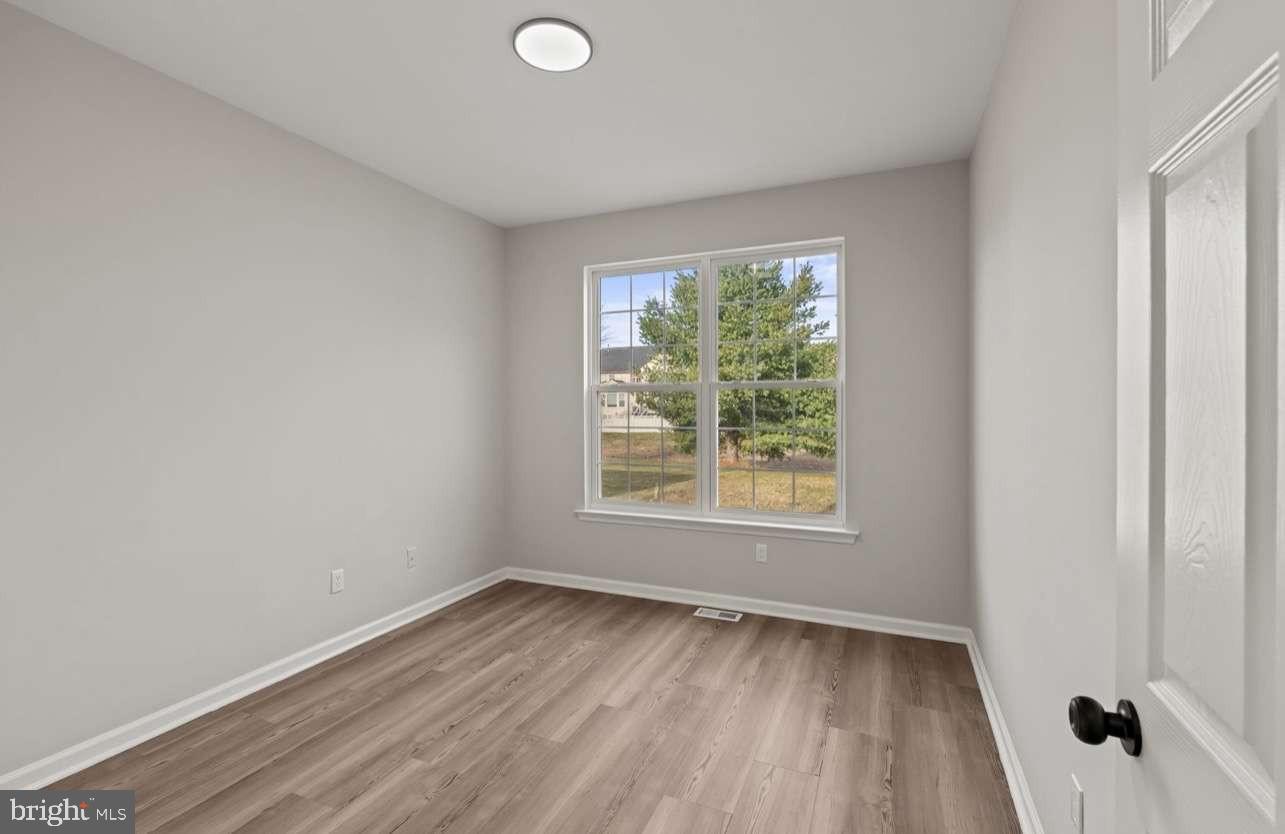 4 Box Turtle Lane Sicklerville, NJ 08081 - Photo 18 of 37 an empty room with wooden floor and windows