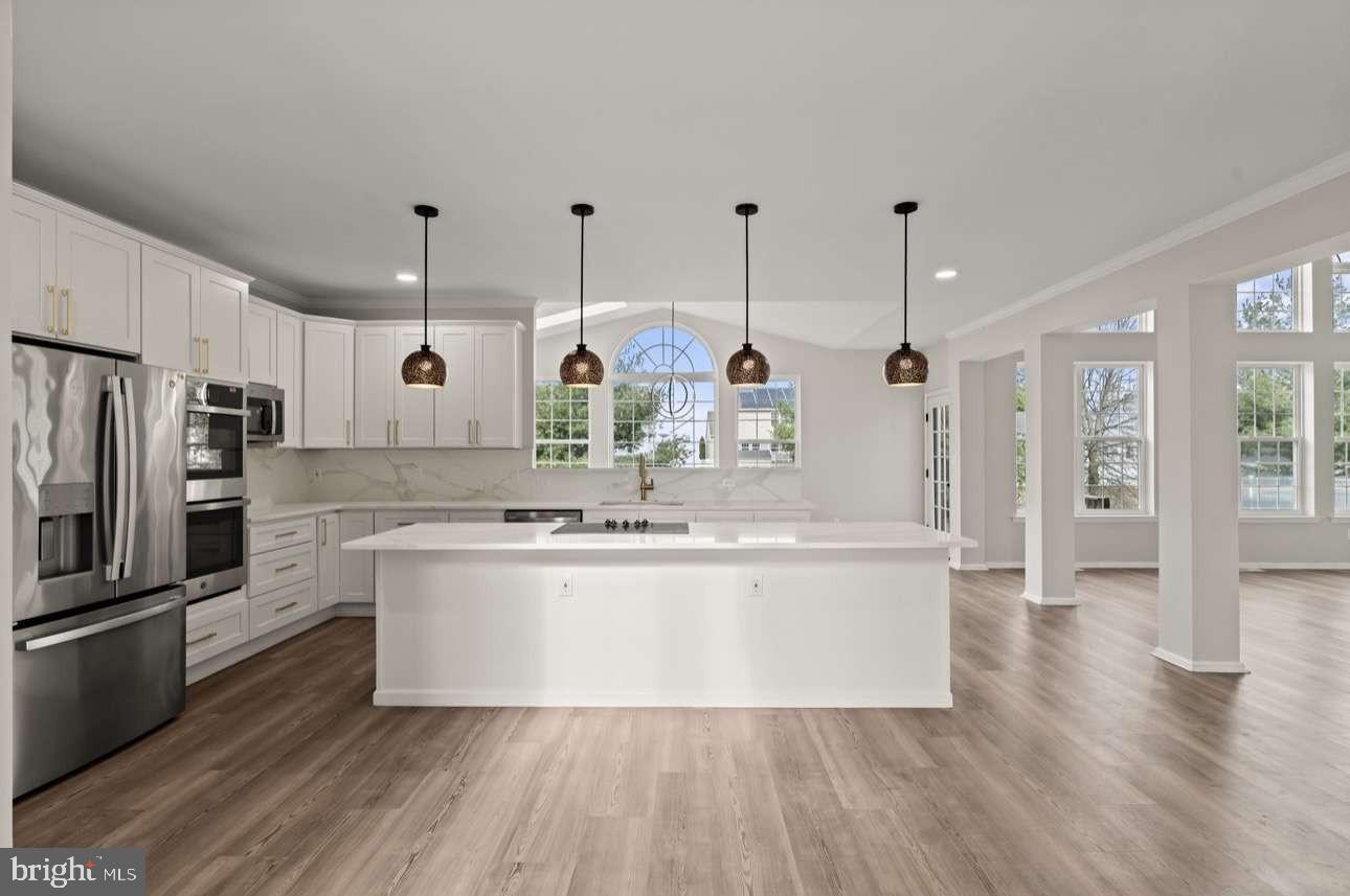 4 Box Turtle Lane Sicklerville, NJ 08081 - Photo 9 of 37 a kitchen with stainless steel appliances granite countertop a sink a stove and a wooden floors