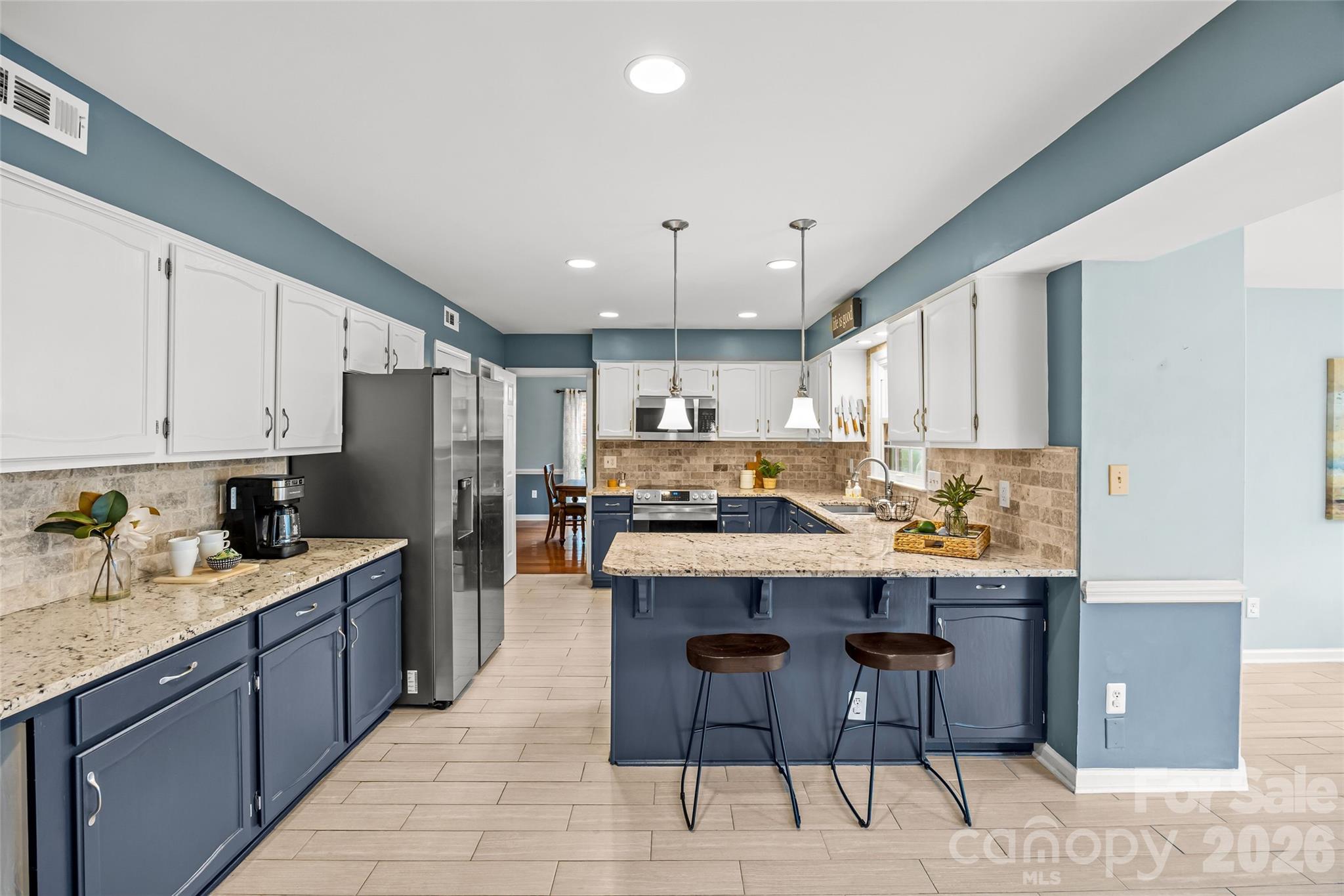 9619 Radner Lane Charlotte, NC 28277 - Photo 15 of 44 a kitchen with kitchen island granite countertop a sink counter top space appliances and cabinets