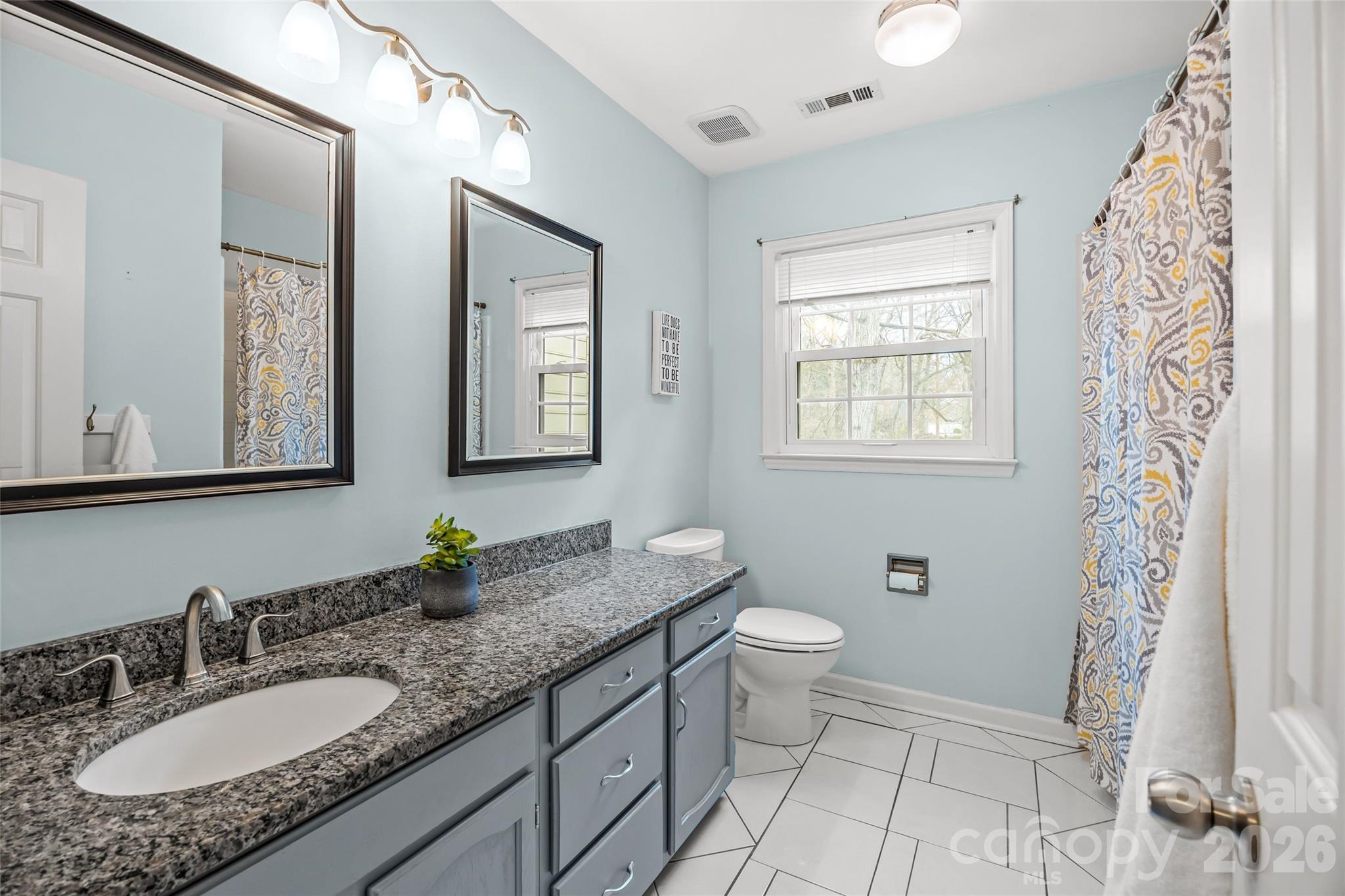 9619 Radner Lane Charlotte, NC 28277 - Photo 29 of 44 a bathroom with a granite countertop sink toilet a mirror a vanity and a shower