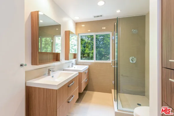a bathroom with a double vanity sink and a bathtub