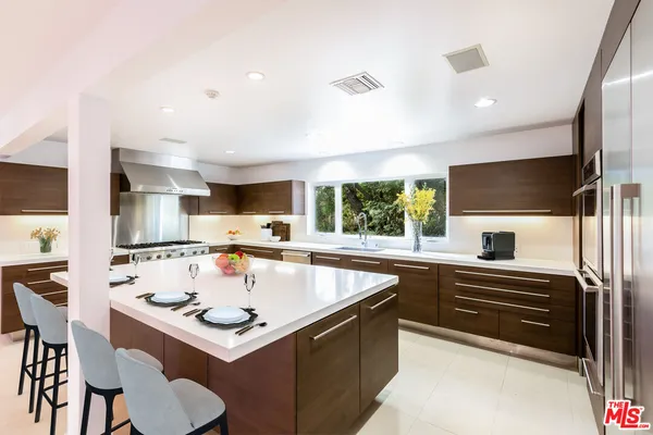 a kitchen with a stove a sink and a refrigerator