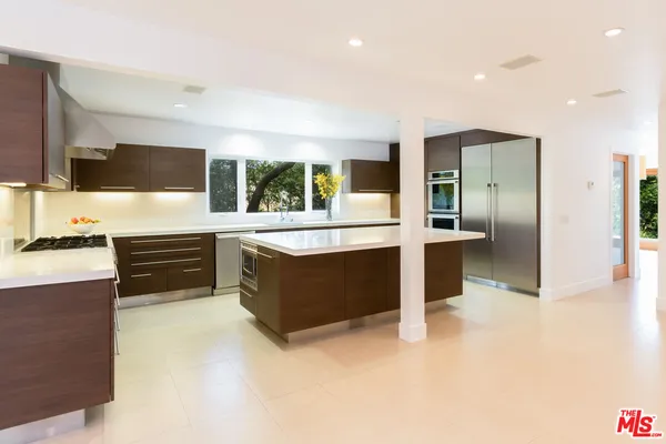 a kitchen with stainless steel appliances a stove and a refrigerator