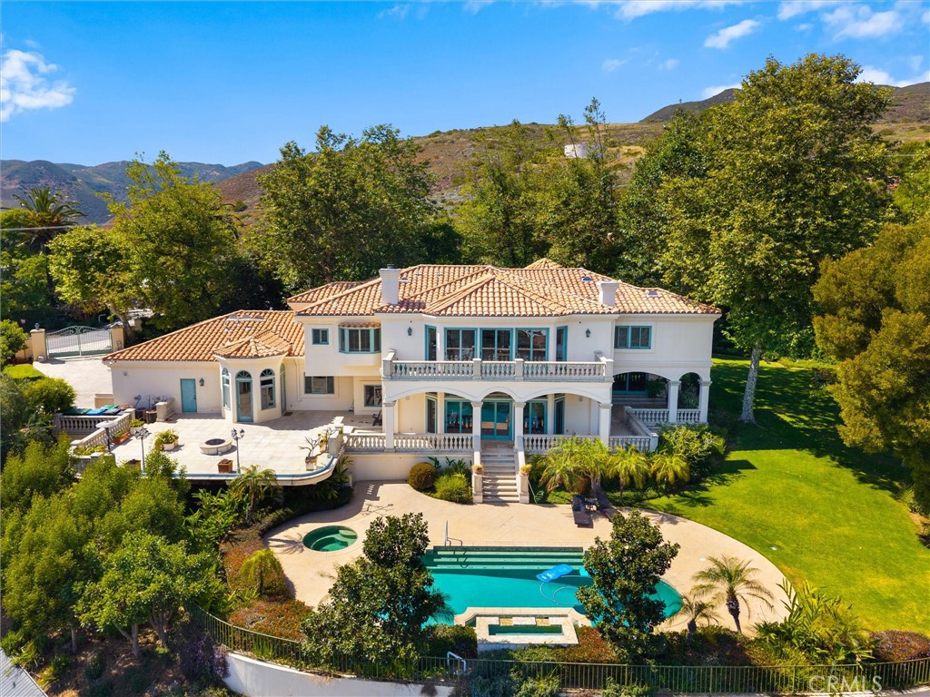 6000 Cavalleri Road Malibu, CA 90265 - Photo 2 of 44 a front view of a house with garden and trees