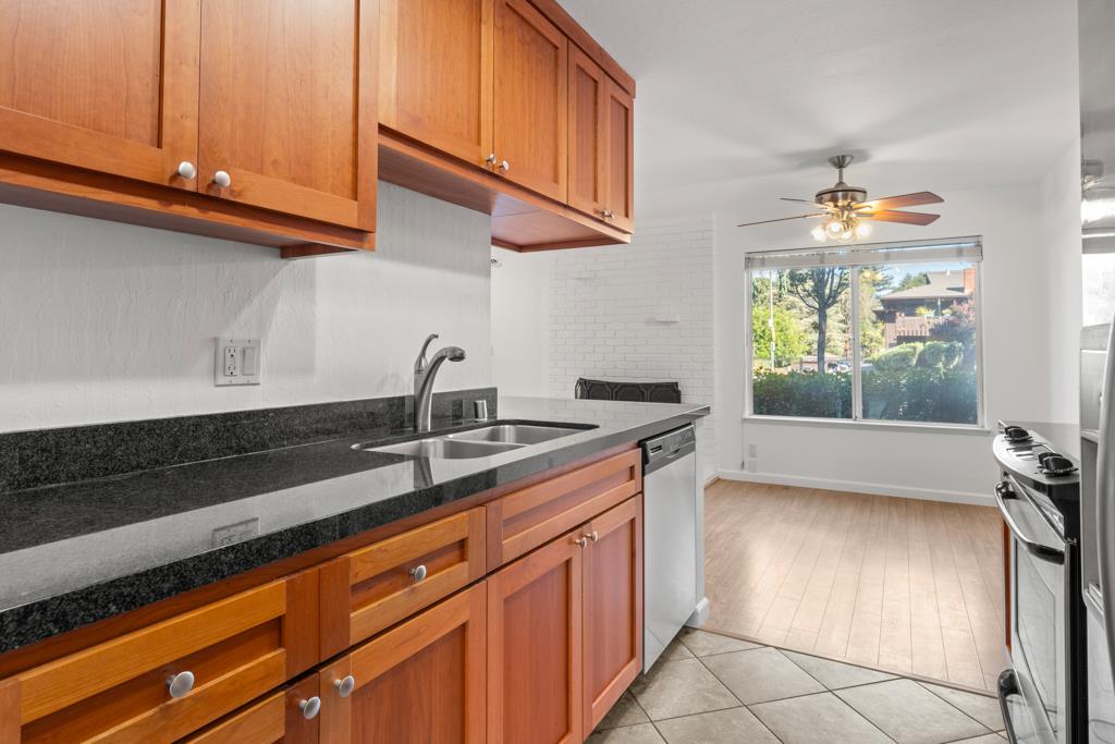 99 East Middlefield Road, Unit 41 Mountain View, CA 94043 - Photo 11 of 37 a kitchen with stainless steel appliances granite countertop a sink and a stove