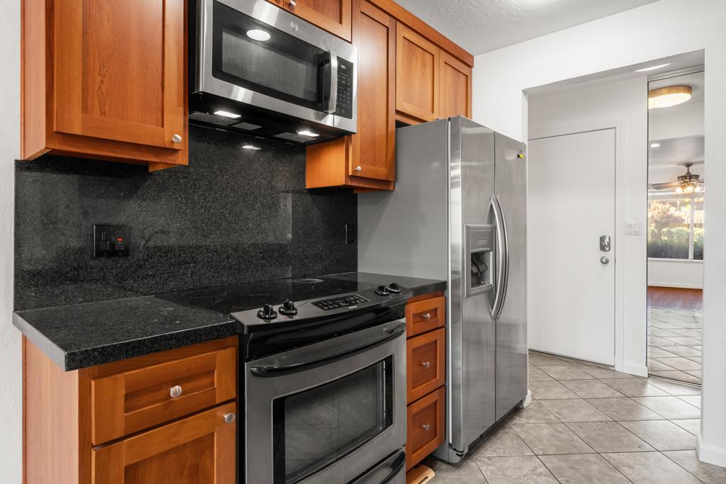 99 East Middlefield Road, Unit 41 Mountain View, CA 94043 - Photo 13 of 37 a kitchen with stainless steel appliances granite countertop a stove a refrigerator and a microwave