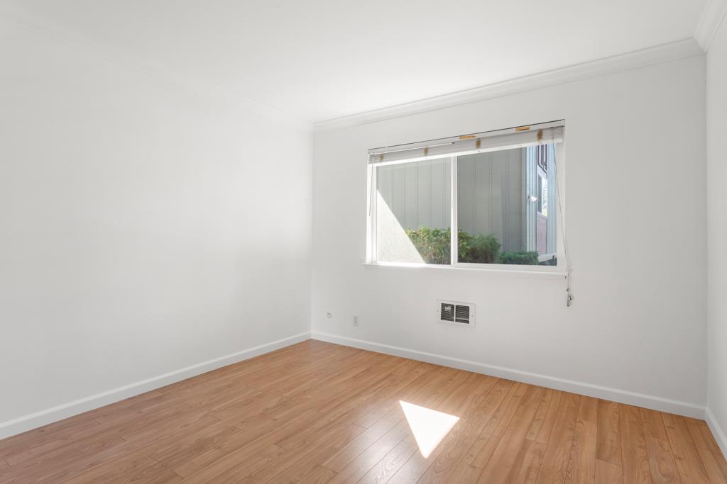 99 East Middlefield Road, Unit 41 Mountain View, CA 94043 - Photo 17 of 37 a view of an empty room with wooden floor and a window