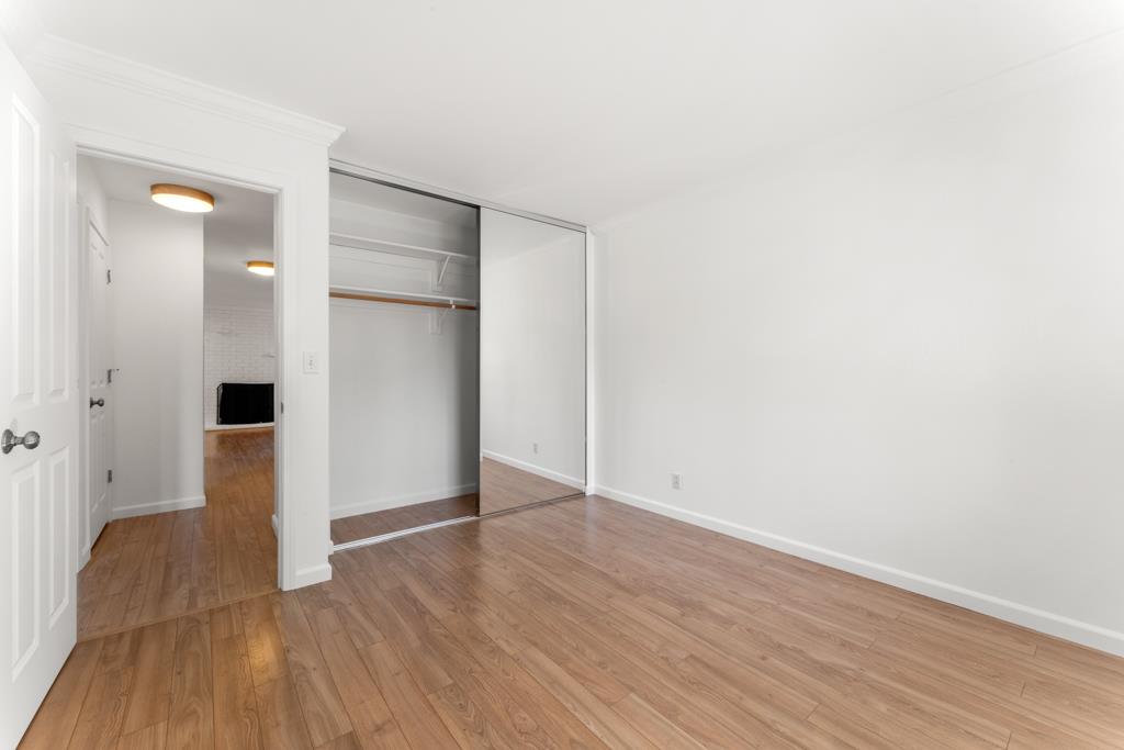 99 East Middlefield Road, Unit 41 Mountain View, CA 94043 - Photo 18 of 37 a view of an empty room with wooden floor and a bathroom