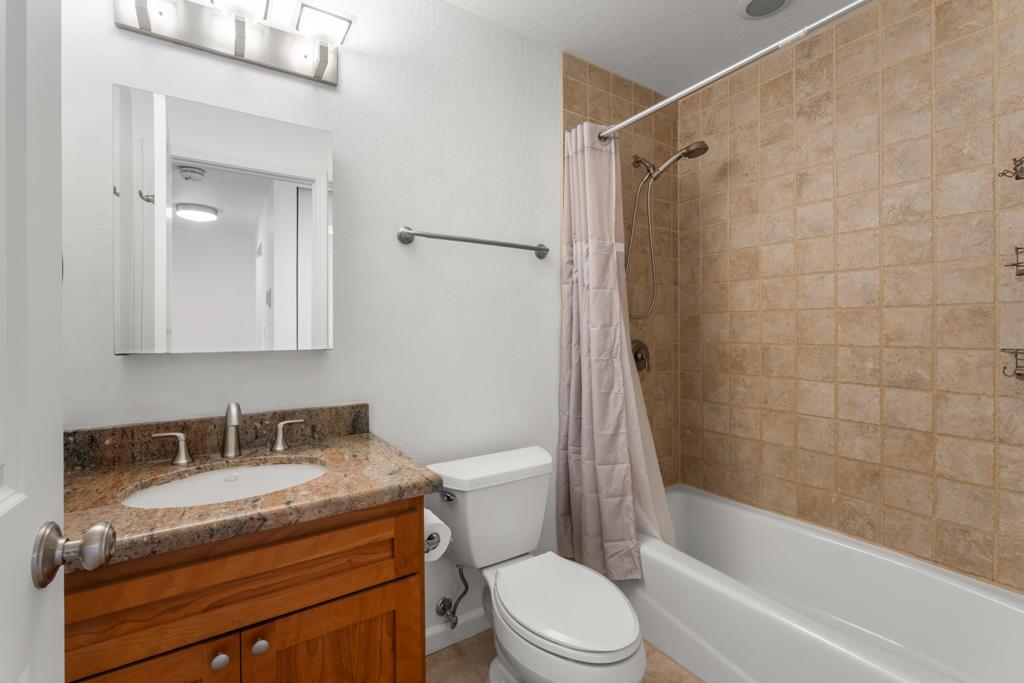 99 East Middlefield Road, Unit 41 Mountain View, CA 94043 - Photo 21 of 37 a bathroom with a granite countertop sink a toilet and shower