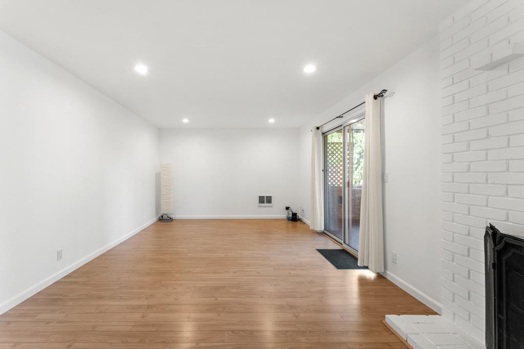 99 East Middlefield Road, Unit 41 Mountain View, CA 94043 - Photo 3 of 37 an empty room with wooden floor and windows