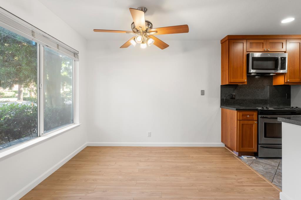 99 East Middlefield Road, Unit 41 Mountain View, CA 94043 - Photo 6 of 37 a view of a kitchen with a sink dishwasher a fireplace with wooden floor
