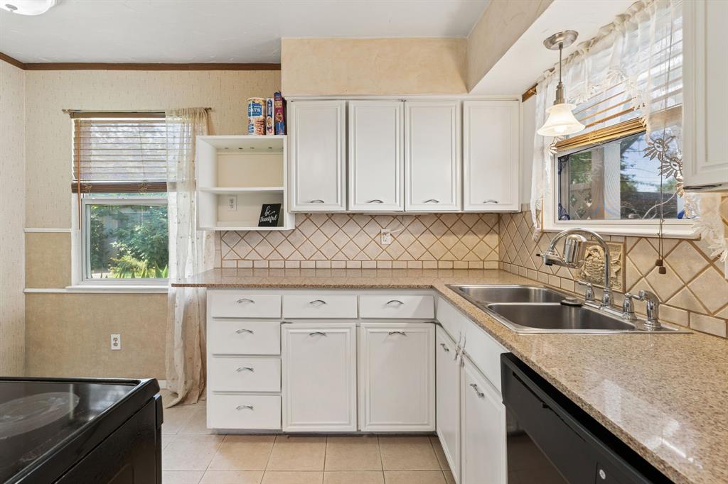 1822 Finley Road Irving, TX 75062 - Photo 15 of 38 a kitchen with granite countertop a sink stove and cabinets