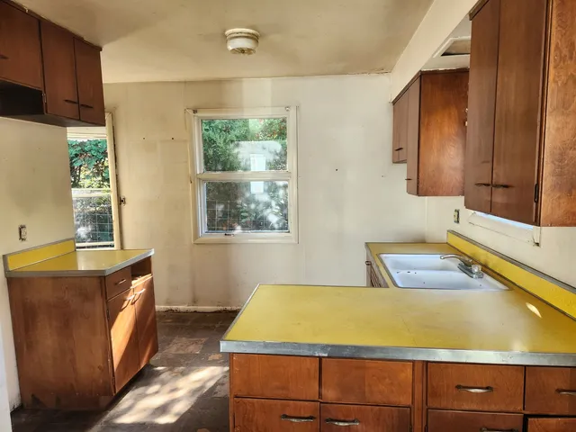 a room with wooden cabinets and a bed