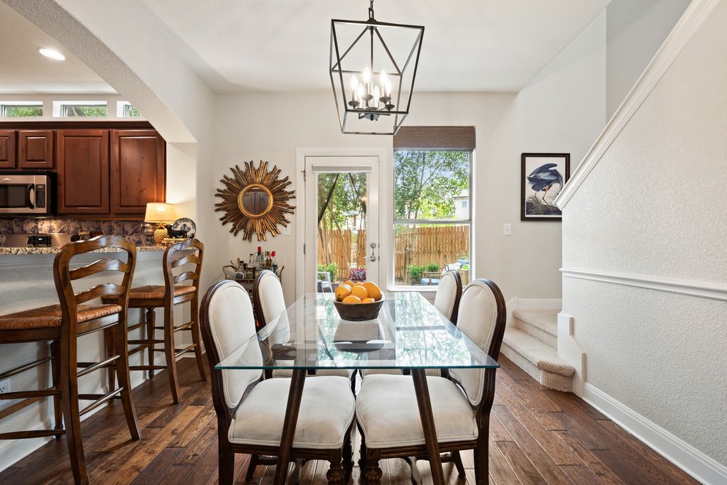 6708 Menchaca Road, Unit 2 Austin, TX 78745 - Photo 14 of 30 Dining area featuring wood-finish flooring and a contemporary chandelier