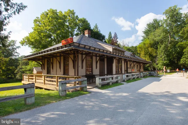 a view of a house with a yard and sitting area