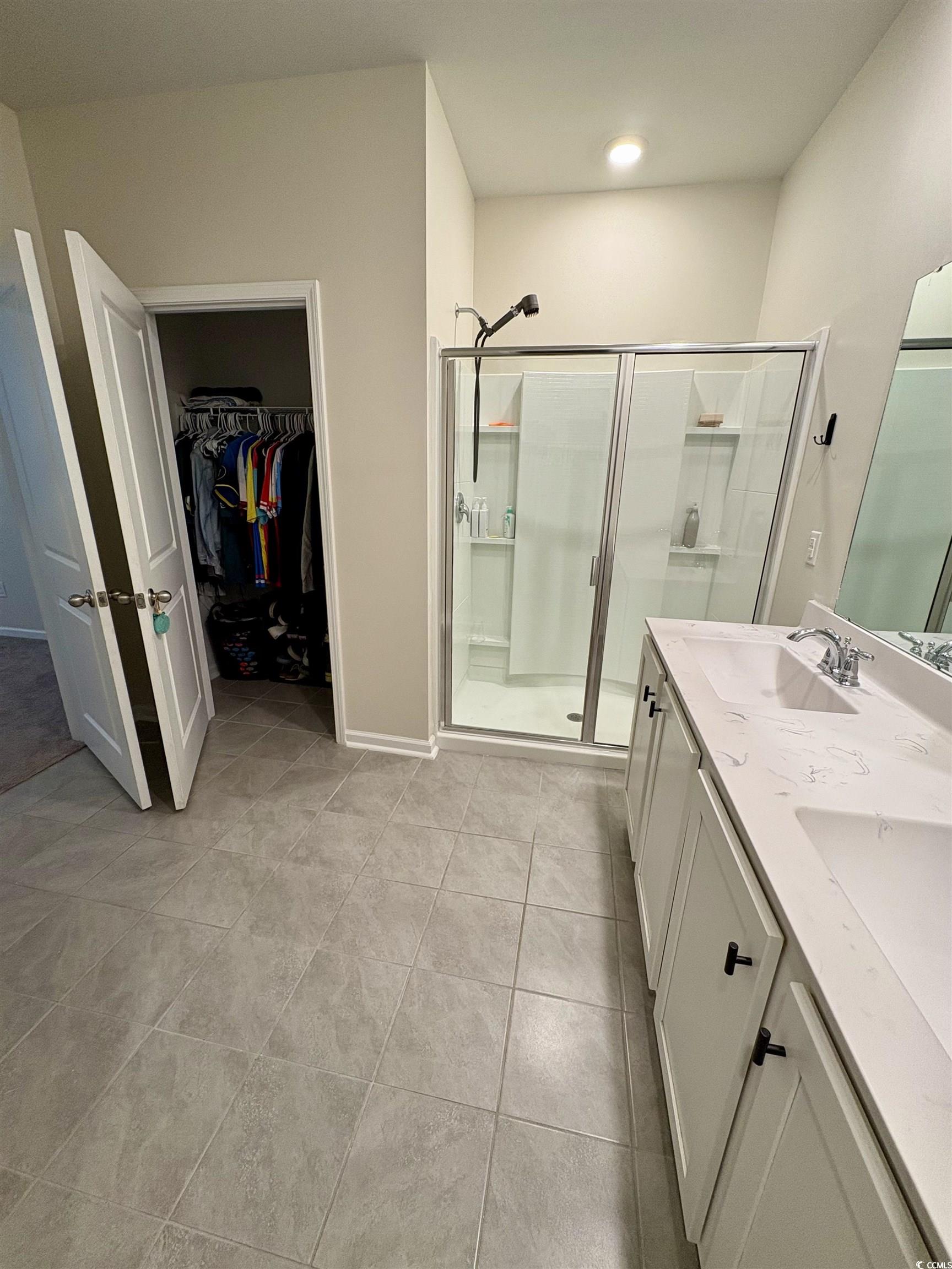 1715 Perthshire Loop Myrtle Beach, SC 29579 - Photo 23 of 39 Bathroom with a shower stall, a walk in closet, double vanity, tile patterned flooring, and recessed lighting