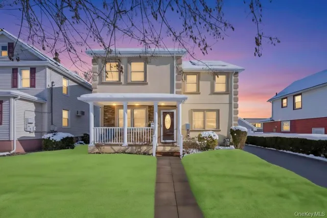 a front view of a house with a garden and porch