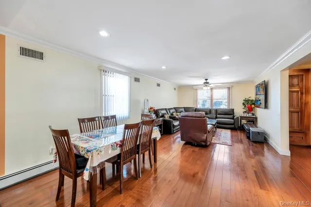 a view of a dining room with furniture and wooden floor