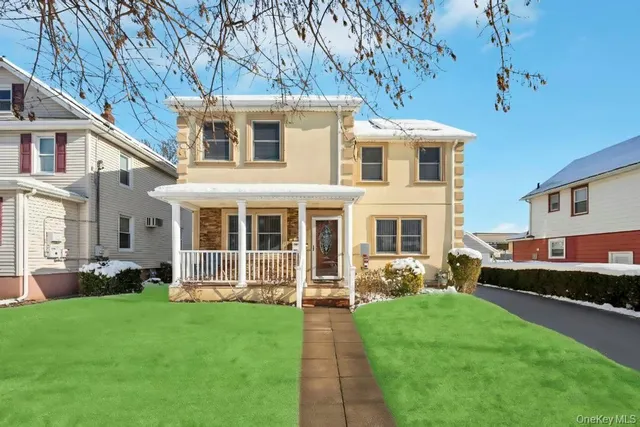 a front view of a house with a yard