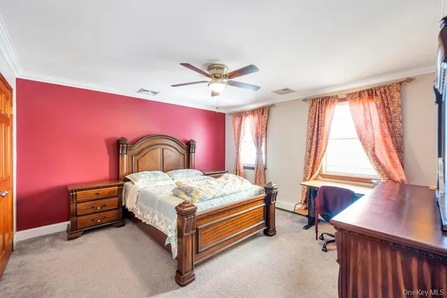 a bedroom with a bed and large window