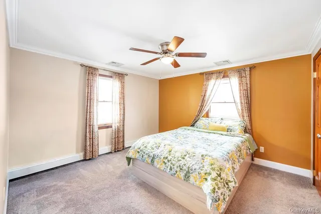 a bedroom with a bed tv and a window