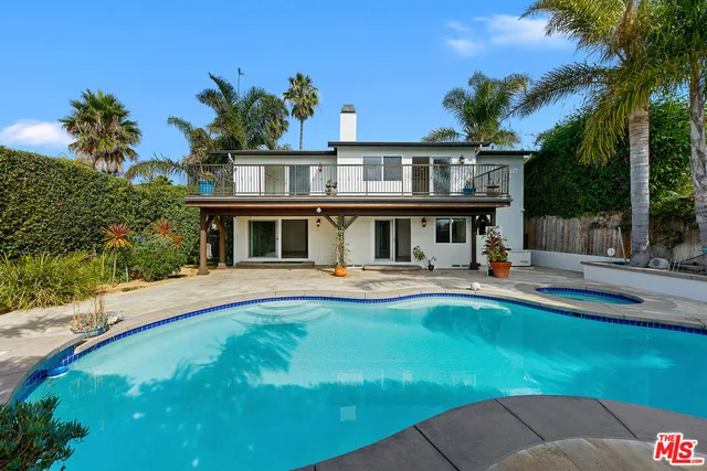 a view of house with swimming pool yard and outdoor seating