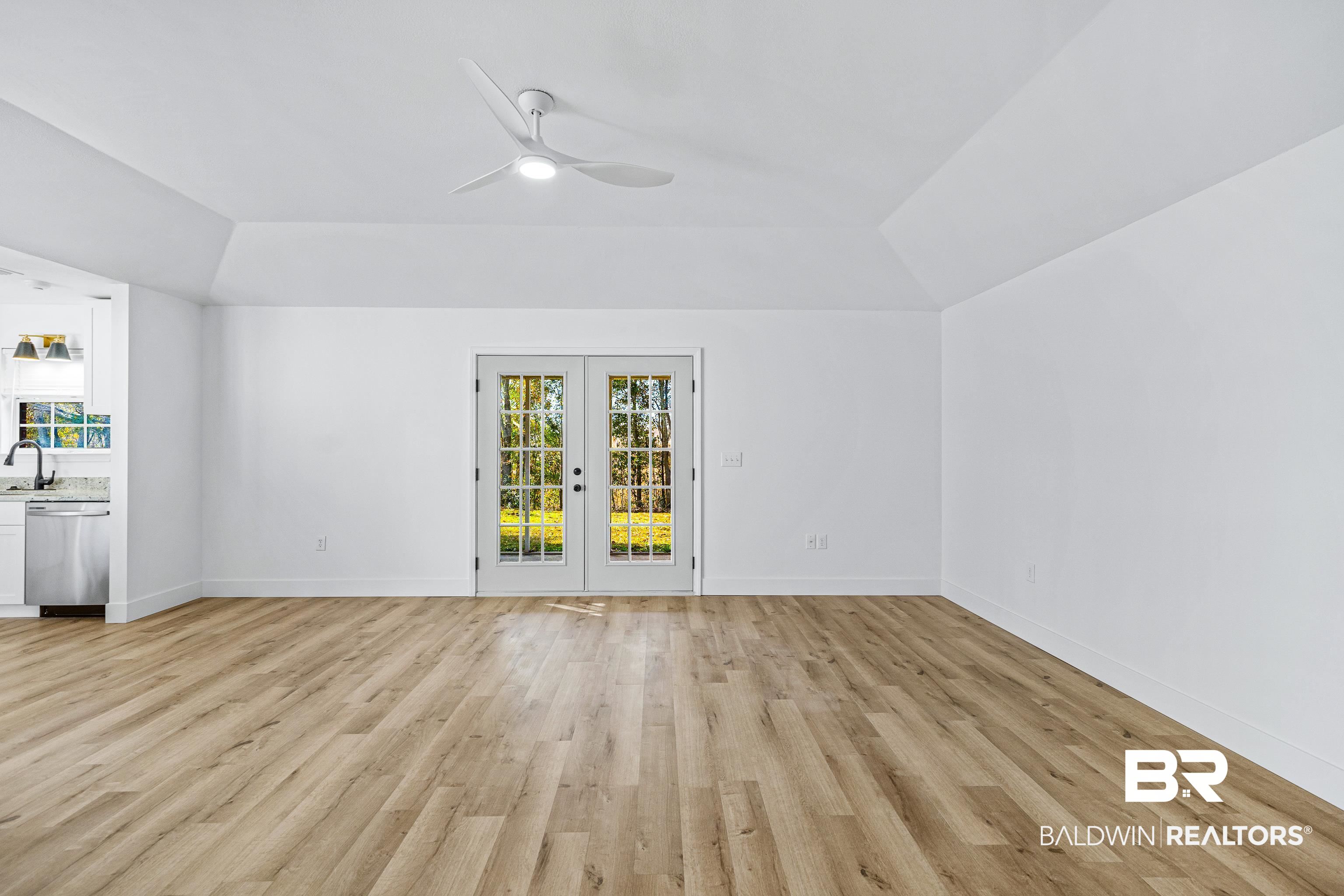 9243 Brookshire Loop Daphne, AL 36526 - Photo 5 of 26 Interior space featuring french doors, ceiling fan, lofted ceiling, and light hardwood / wood-style floors
