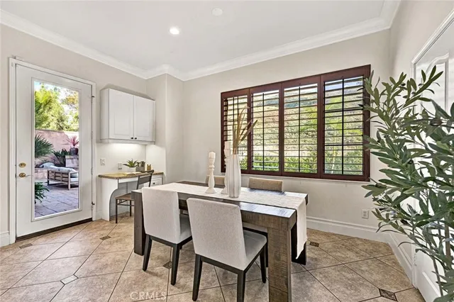 a kitchen with a table chairs and window