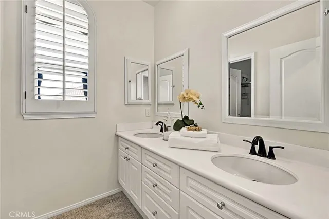 a bathroom with a toilet a sink and a window