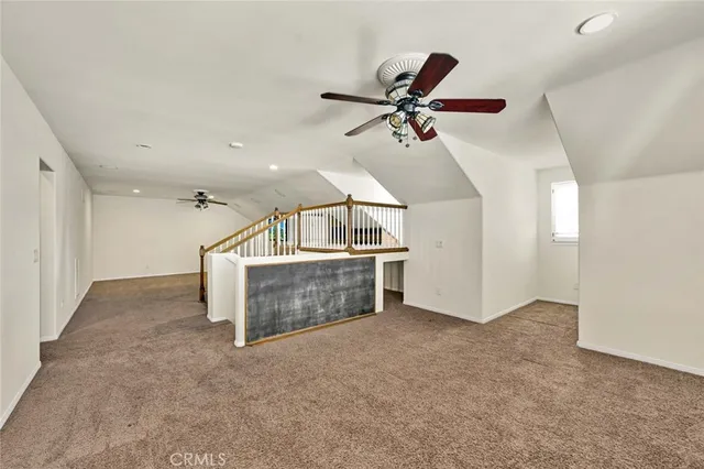 a view of a livingroom with a ceiling fan and hardwood floor