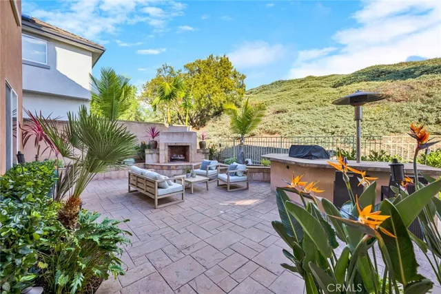 a view of a patio with couches and table and chairs and potted plants
