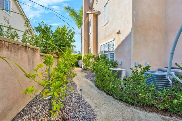 a front view of a house with a garden and trees