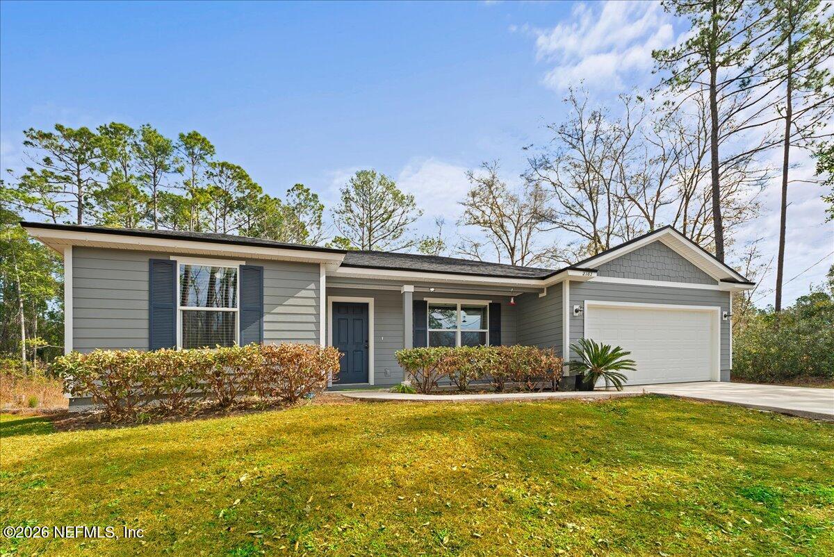 a front view of house with yard and green space