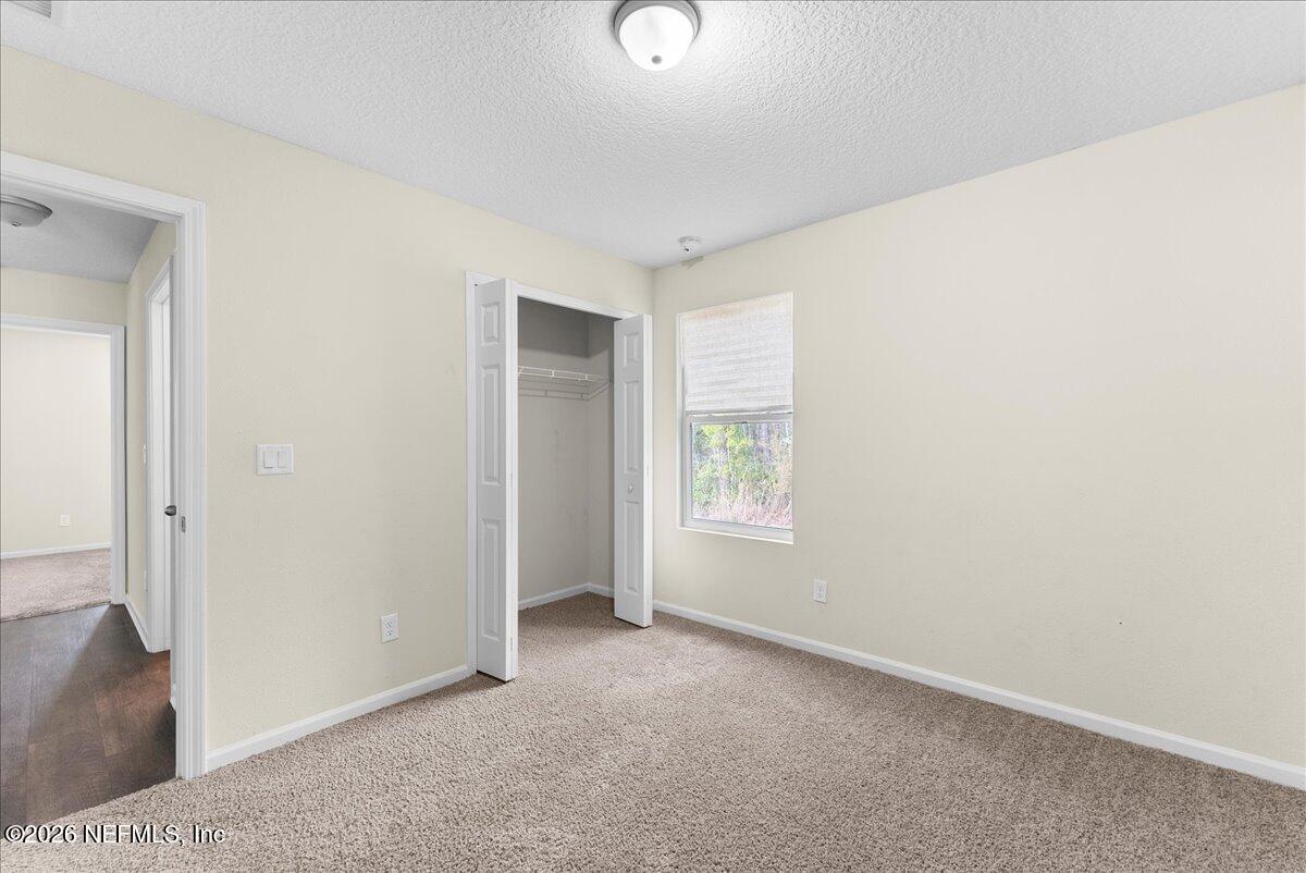 2383 Daisy Street Middleburg, FL 32068 - Photo 15 of 33 an empty room with windows and closet