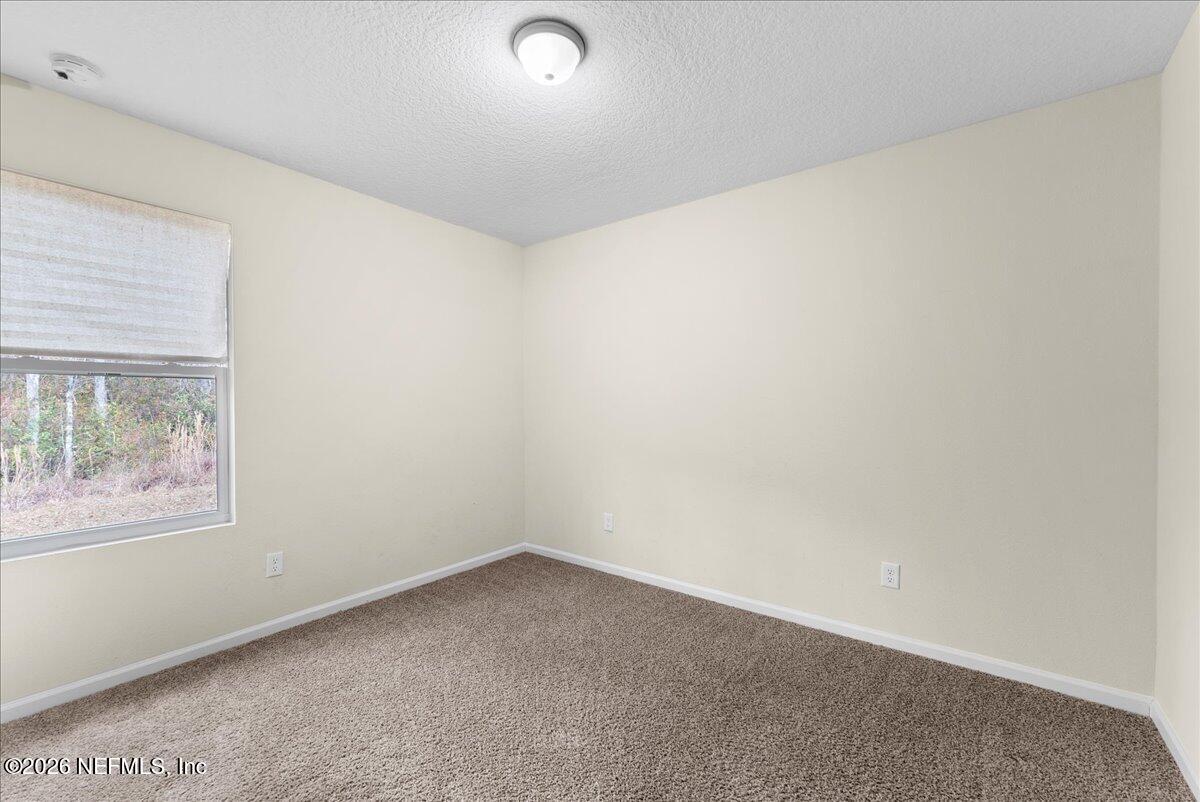 2383 Daisy Street Middleburg, FL 32068 - Photo 16 of 33 an empty room with a window