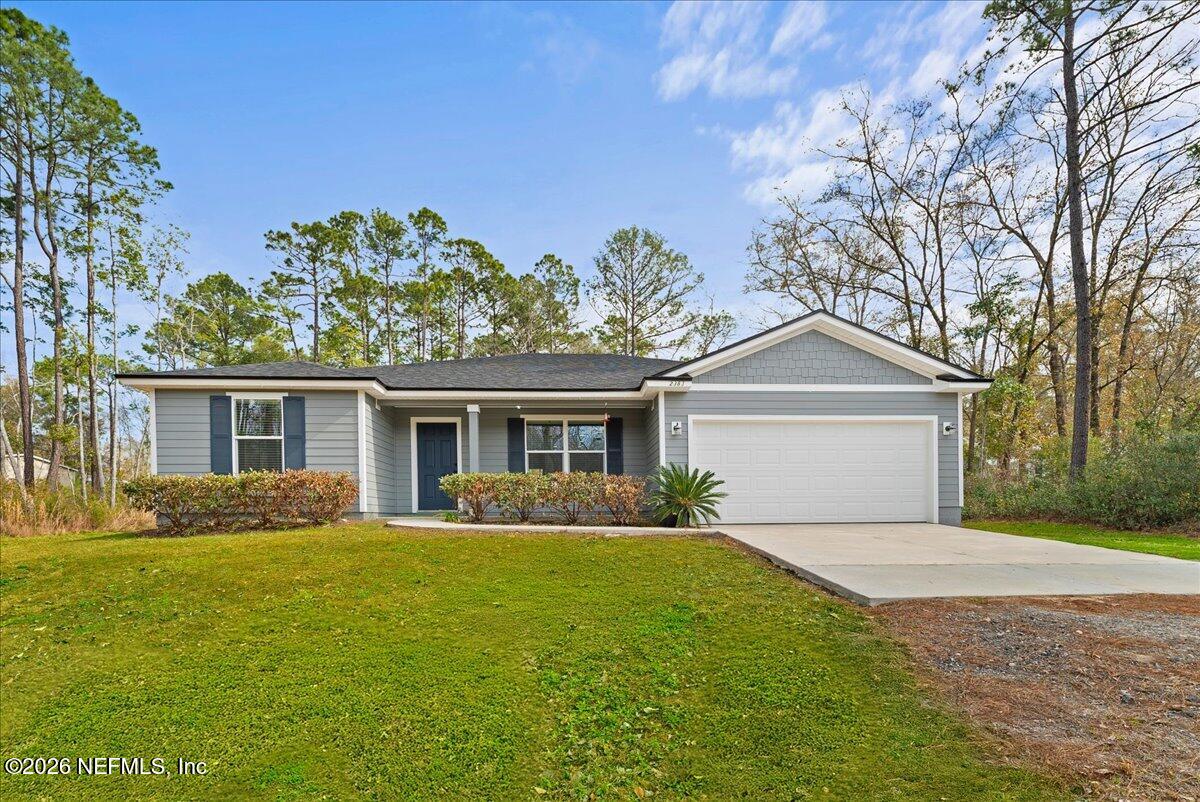 2383 Daisy Street Middleburg, FL 32068 - Photo 2 of 33 a front view of a house with a garden