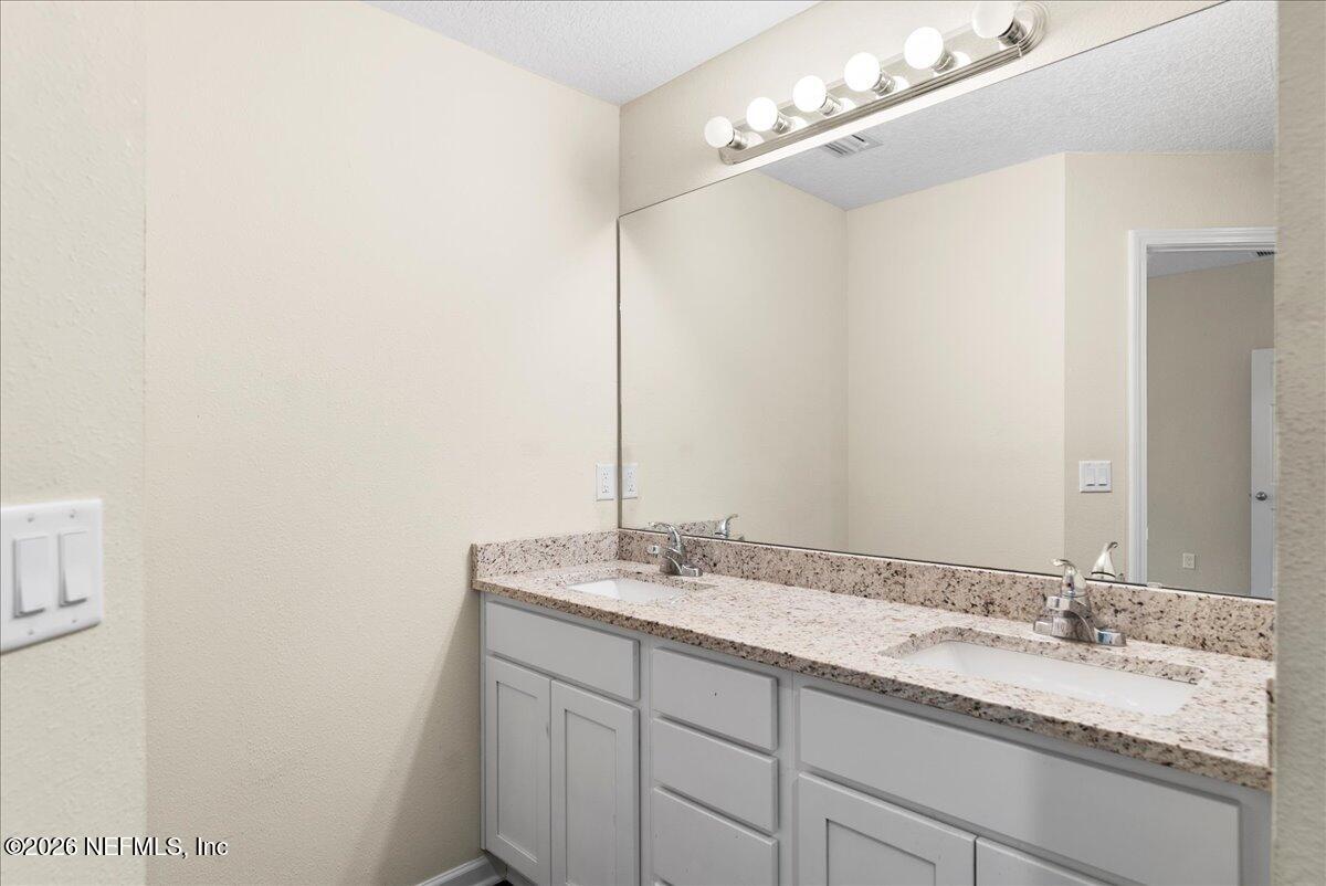 2383 Daisy Street Middleburg, FL 32068 - Photo 25 of 33 a bathroom with a granite countertop sink and a mirror