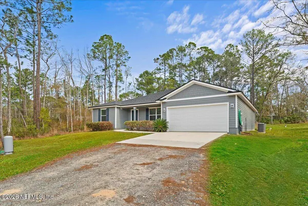 a front view of house with yard and green space