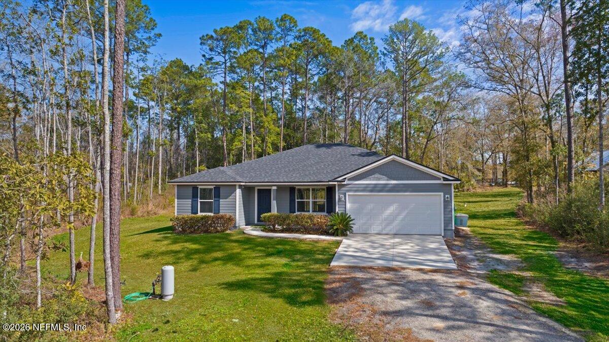 2383 Daisy Street Middleburg, FL 32068 - Photo 31 of 33 a front view of a house with garden