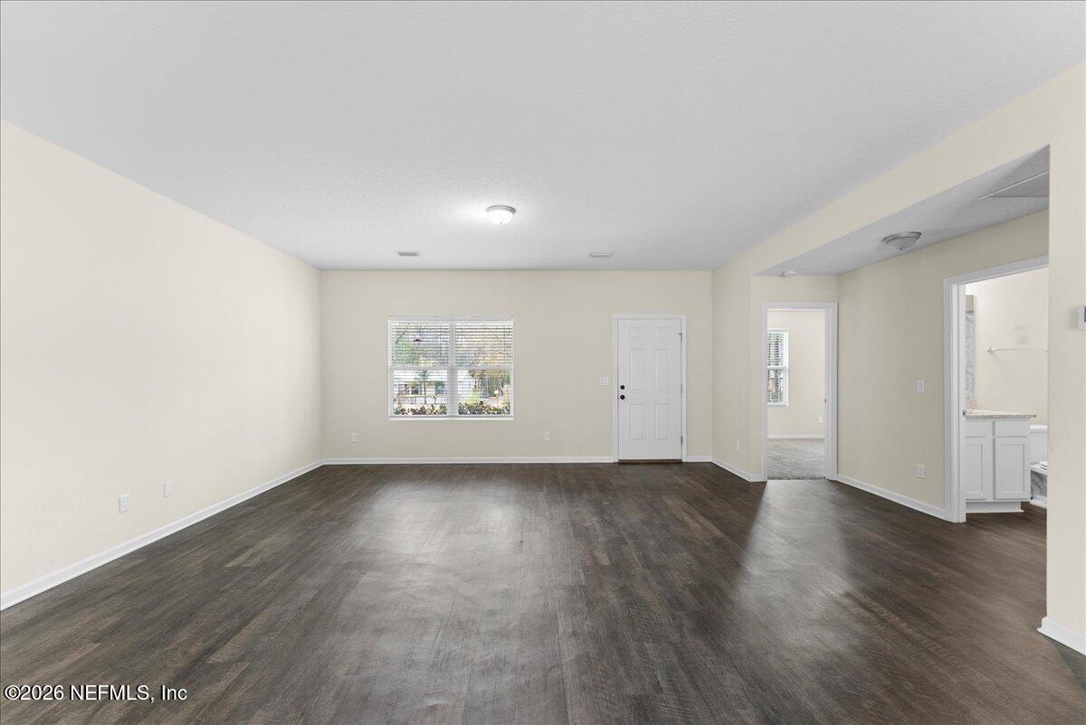 2383 Daisy Street Middleburg, FL 32068 - Photo 6 of 33 an empty room with wooden floor and window