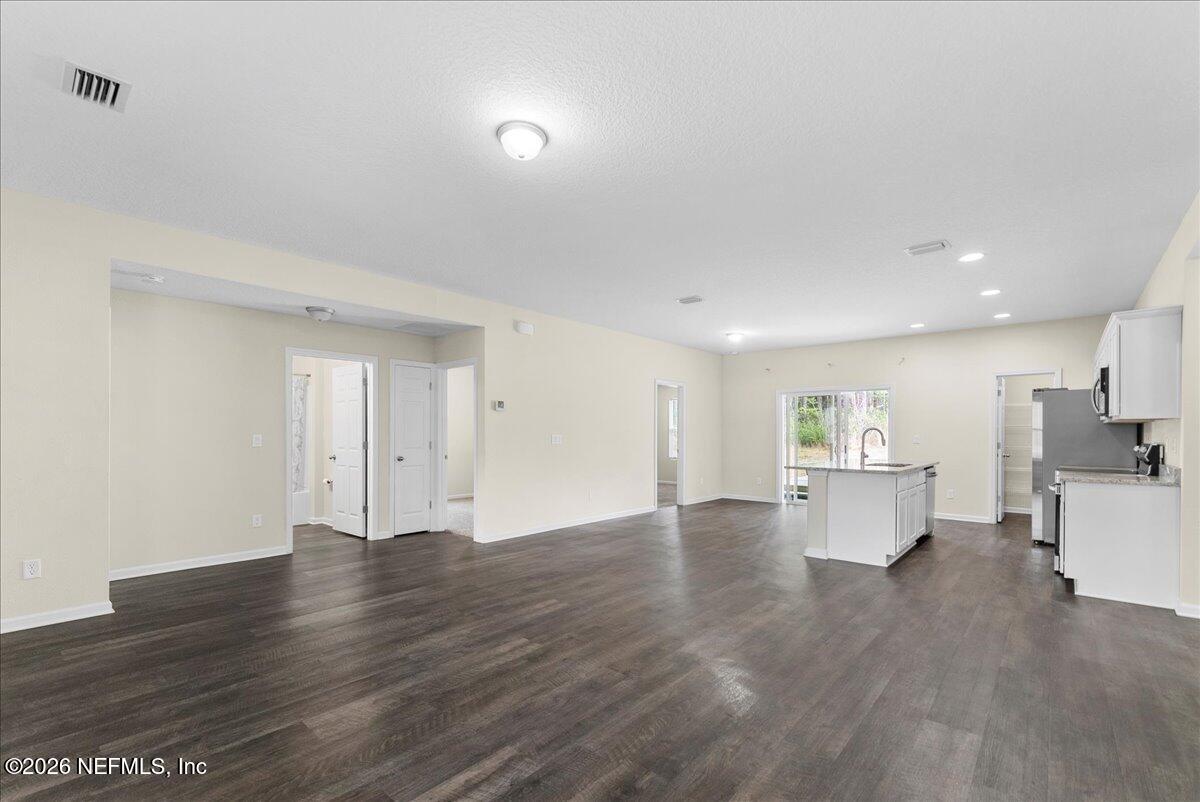 2383 Daisy Street Middleburg, FL 32068 - Photo 8 of 33 a view of empty room with wooden floor and window