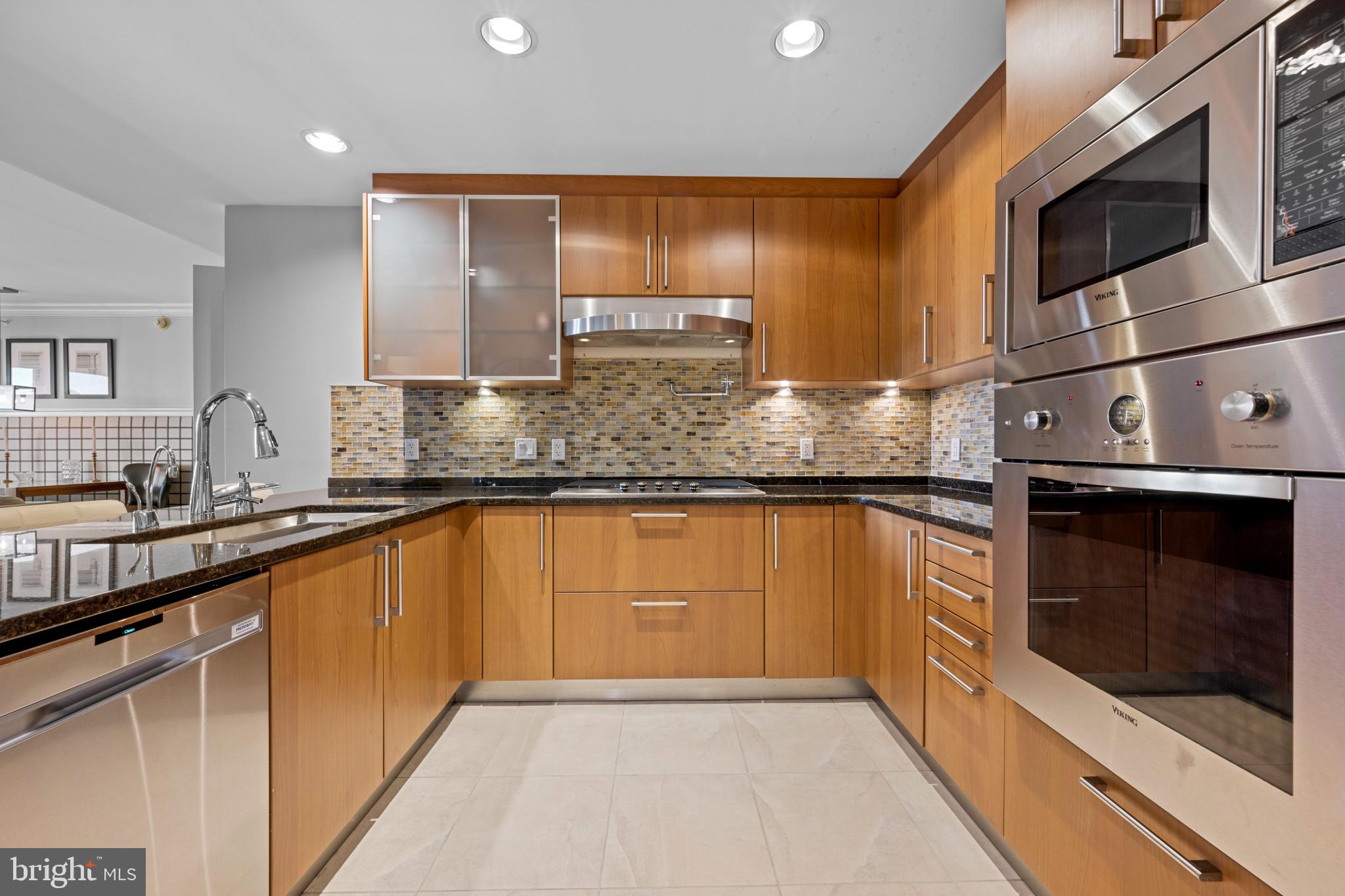801 Key Highway, Unit 458 Baltimore, MD 21230 - Photo 13 of 48 a kitchen with stainless steel appliances granite countertop a sink stove and microwave